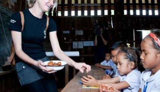 WFP/Bart Verweijb Jessica Watson distributes school lunches at a school on a visit to Laos in 2011.